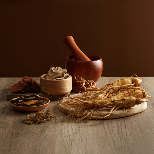 Ginseng root, sliced ginseng, and other assorted ginseng root variations in wooden bowls and plates